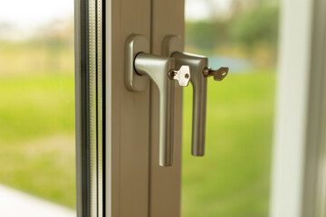 Close Up of a Window Handle with a Key