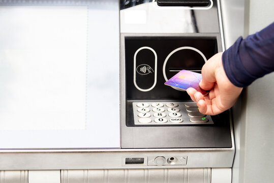 Person using contactless payment at an ATM machine