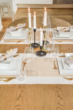 Elegant Table Setting with Lit Candles and Gold Accents