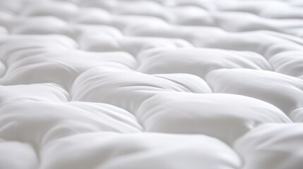 Obraz premium Close-up view of a soft, plush white mattress, showcasing its comforting texture and unique tufted design for restful sleep.