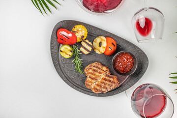 Steak with grilled vegetables and red wine, delicious and healthy food for lunch or dinner. dietary meat and vegetables, top view. copy space