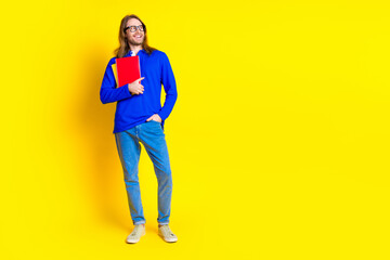 Photo of clever handsome man wear trendy blue pullover look empty space isolated on yellow color background