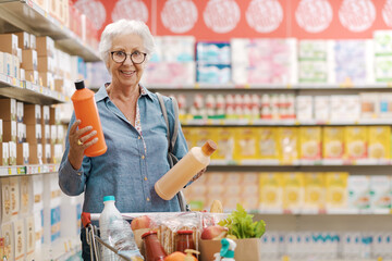 Senior customer comparing products at the supermarket