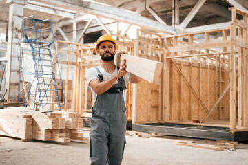 The wooden plank. Industrial worker in warehouse