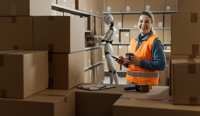 Warehouse worker taking a break while a robot is working