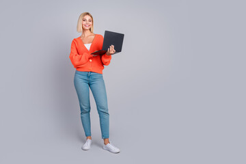 Full size photo of pretty young girl laptop empty space isolated on grey color background