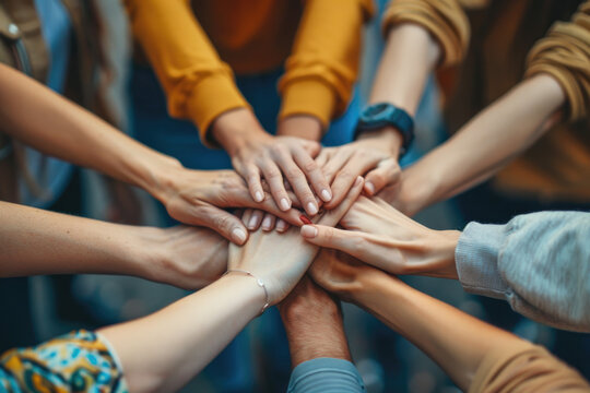 Diverse Group of People Stacking Hands Together in Unity and Teamwork