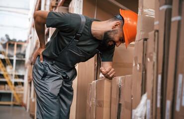 Back is hurting, spine pain. Foreman is in the storehouse, shipping distribution business
