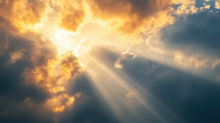 Golden sun rays pierce through dark, dramatic clouds, creating a breathtaking contrast of light and shadow in the sky.