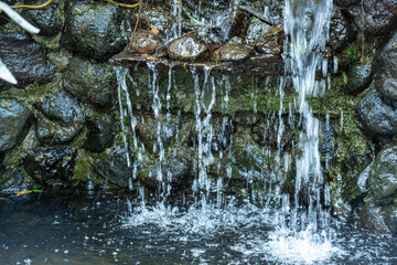 Waterflow from the rocks in a garden-style restaurant, similar to a mini waterfall