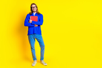 Fototapeta premium Photo of cheerful handsome man wear trendy blue clothes empty space isolated on yellow color background
