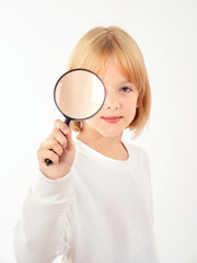 A blonde girl is photographed for a school album in a studio with a movie camera