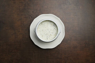 Azerbaijani Dovga soup in a white bowl, top view. Healthy soup with fermented milk and various greens