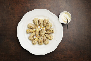 Azerbaijan national cuisine gurza in a white bowl. Dumplings, dough stuffed with meat