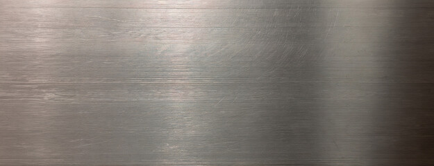 Polished platinum texture background with abstract light reflections creating a sleek, metallic surface.