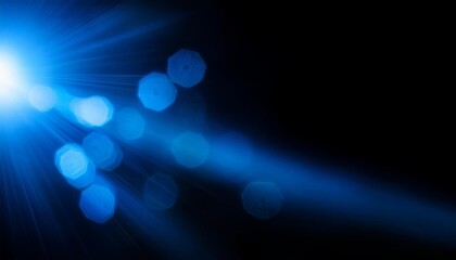 abstract blue lens flare on black background, bokeh defocused lights and shadow overlay for photography