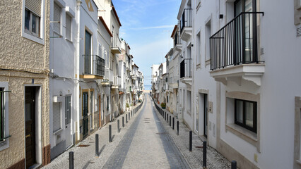 Narrow Street Leading to the Ocean in the Morning in Nazaré, Portugal