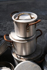 Many unused aluminum cooking pots