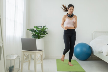 Fototapeta premium Portrait of sport slim fit strength asian woman training in sportswear relax and practicing yoga, fitness, exercise, wellness, workout, sport at home.Diet concept.Fitness and healthy lifestyle