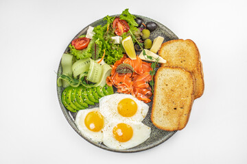 Breakfast with smoked salmon, sunny side eggs, avocado vegetables salad and toasts, banner, menu, recipe copy space, top view