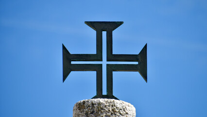 Iron Portuguese Cross with Sky Blue Background in Nazaré