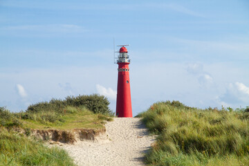 Path through the dunes to the red lighthouse of the Dutch island Schiermonnikoog © Matauw