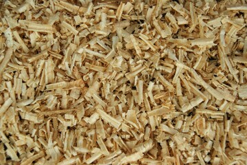 Screen background from wood shavings. Carpenter's workshop.