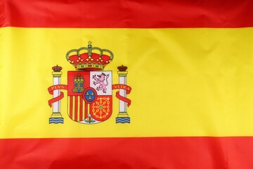 The national flag of Spain with its vibrant colors and coat of arms prominently displayed