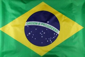 Brazilian flag featuring the green field, yellow diamond, and blue globe with stars emphasizing the...