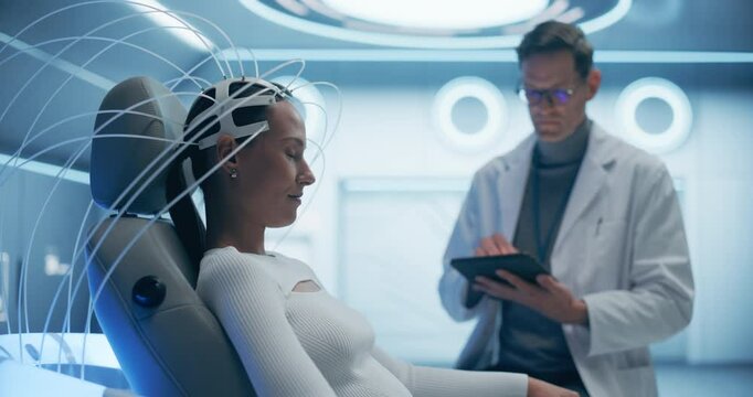 Futuristic laboratory: Female Patient Wearing Headset for a Brain Scan With Advanced Neural Technology, Monitored by a Doctor Using Digital Tabelt. Neural Disease Research. Pan Shot