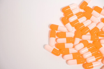 a collection of orange capsules on a white background