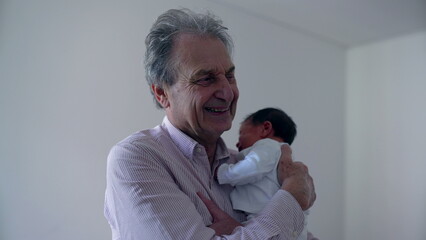 Naklejka premium Grandfather holding newborn baby close to his face, showing tender affection and love, emphasizing the special bond between grandparent and child