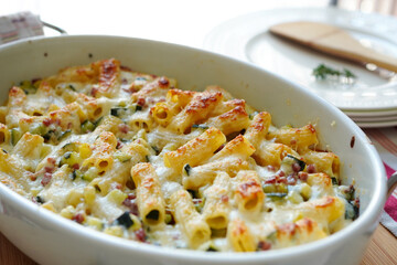 Homemade macaroni gratin made with zucchini and ham 