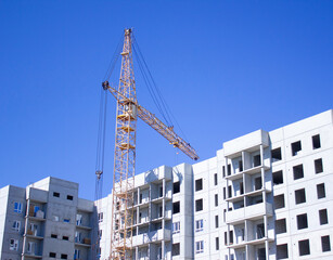 A construction crane on the construction of an apartment building. Industrial construction of...