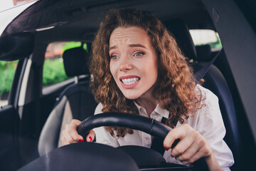 Photo of scared shocked woman wear white shirt driving auto first time outdoors urban city street