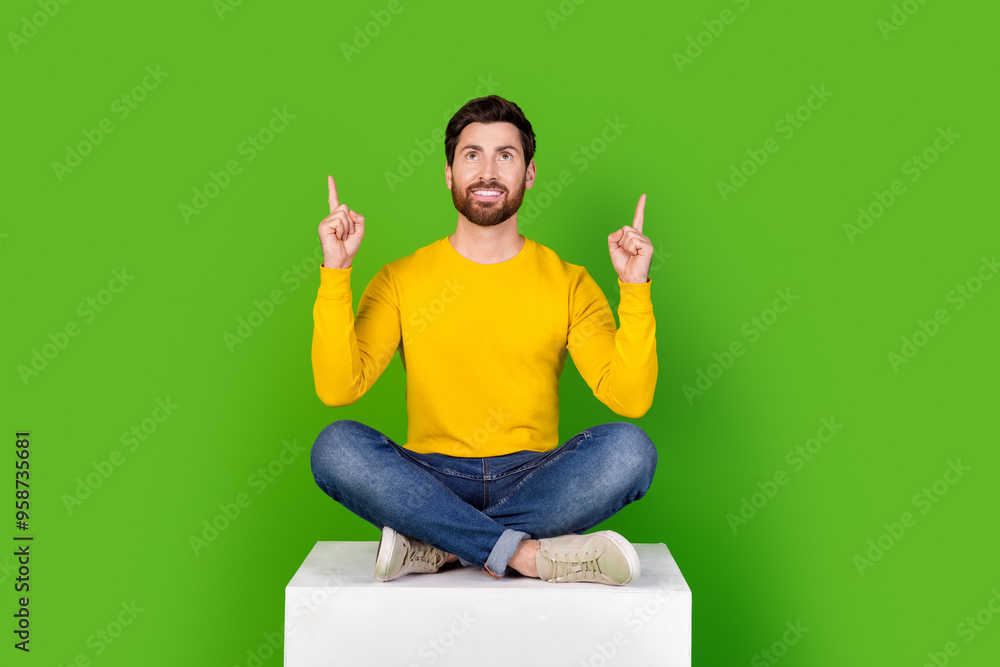 Poster full body photo of attractive young man sit white cube point look up empty space dressed yellow clot