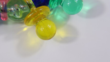 Focus on first floor toy necklace colorful plastic pacifiers with copy space