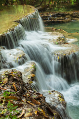 Fototapeta premium Cascading pools at Kuang Xi Waterfall near Luang Prabang, Laos - Beautiful turquoise blue waterfalls in Asia