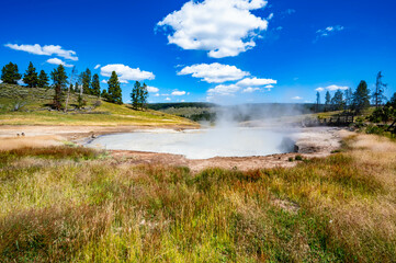 Yellowstone National Park Mud Volcano and Dragon Mouth hike with geyser eruptions spewing hot...