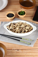 dish of hot mushrooms, in butter and decorated with chives