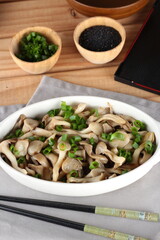 dish of hot mushrooms, in butter and decorated with chives