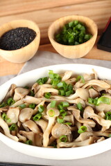 dish of hot mushrooms, in butter and decorated with chives