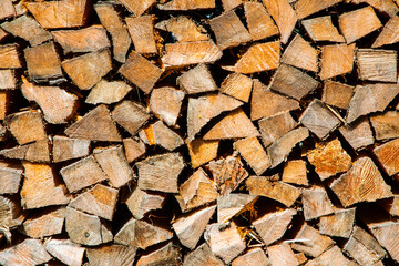 a stack of chopped firewood in alps