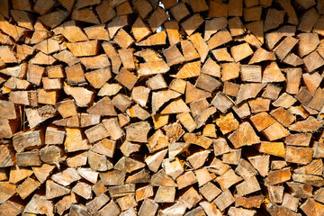 a stack of chopped firewood in alps