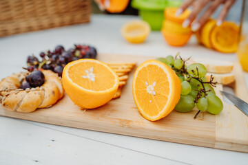 Close up of woman's hands using hand juicer for orange and lemon