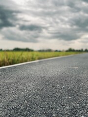 Rural Road under Cloudy Sky