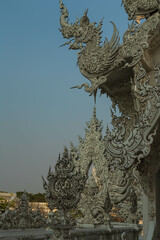 Fototapeta premium Chiang Rai, Thailand - March 2020: Part of the exterior of White temple or Wat Rong Khun. Details