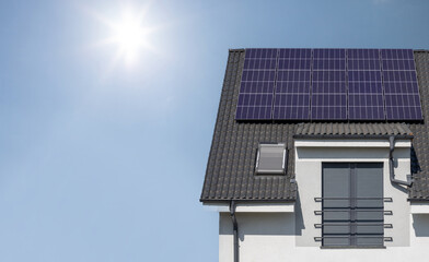 Fototapeta premium Solar Panels on House Roof in Sunlight