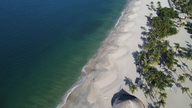 Aerial drone view of Puerto Cruz beach near the Zaragoza lighthouse, Margarita Island, 'la Perla del Caribe' in Venezuela, on a sunny day.
