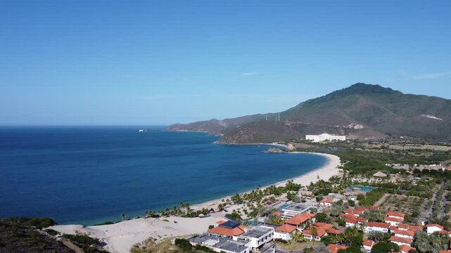 Aerial drone view of Puerto Cruz beach near the Zaragoza lighthouse, Margarita Island, 'la Perla del Caribe' in Venezuela, on a sunny day.